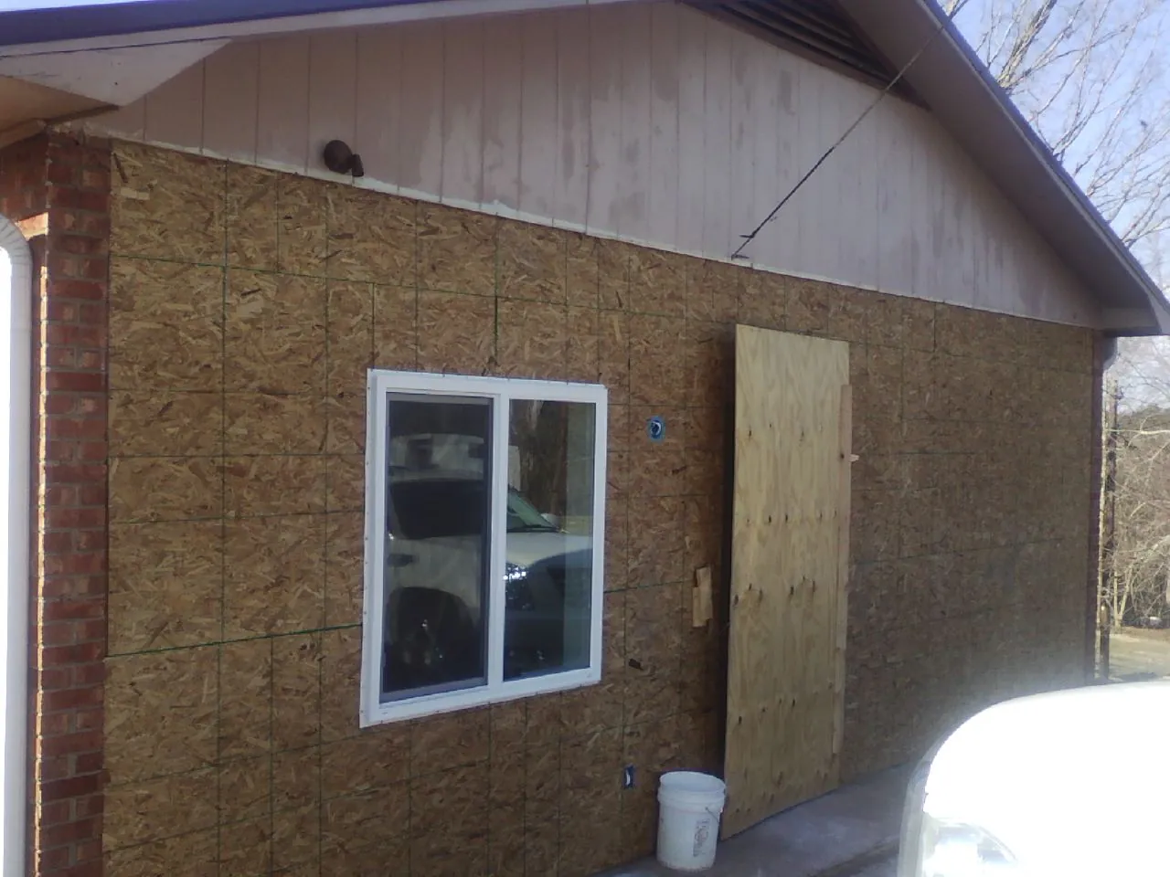 OSB sheathing on a garage addition wall before siding in Weidman